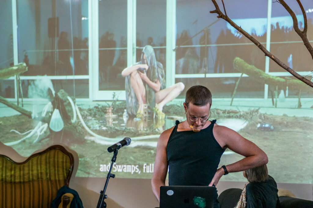 Venus Jasper presenting an artist talk about ecological decay, swamps and the unknown