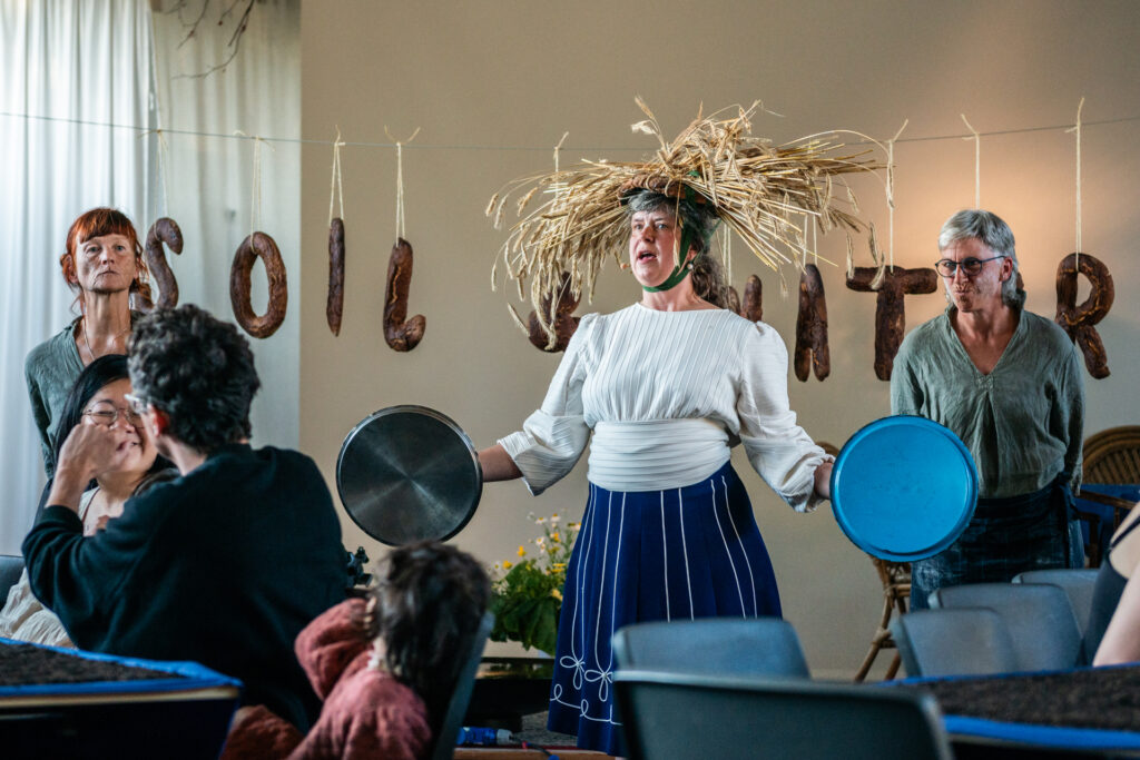 Tina Andersen performing 'The Harvest Dinner', a staged dinner with the theme of soil and water